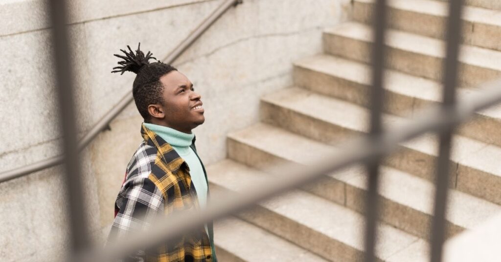 african american male climbing outdoor steps