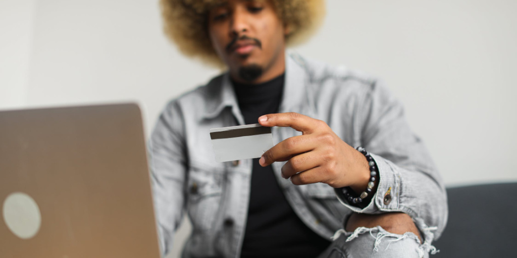 african american male with credit card buying online