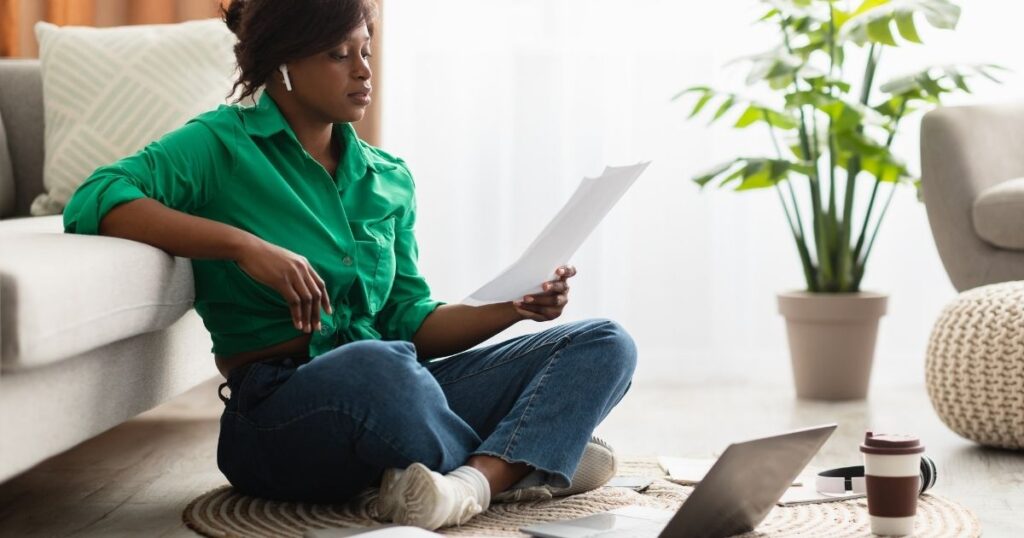 african american woman wearing earbuds listening to a podcast