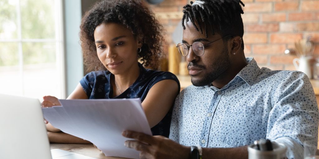 black millennial couple reviewing finances